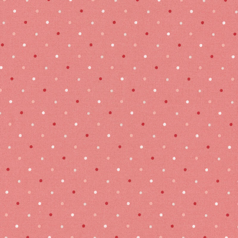Coral pink fabric with a white, pink, and red polka dot pattern.