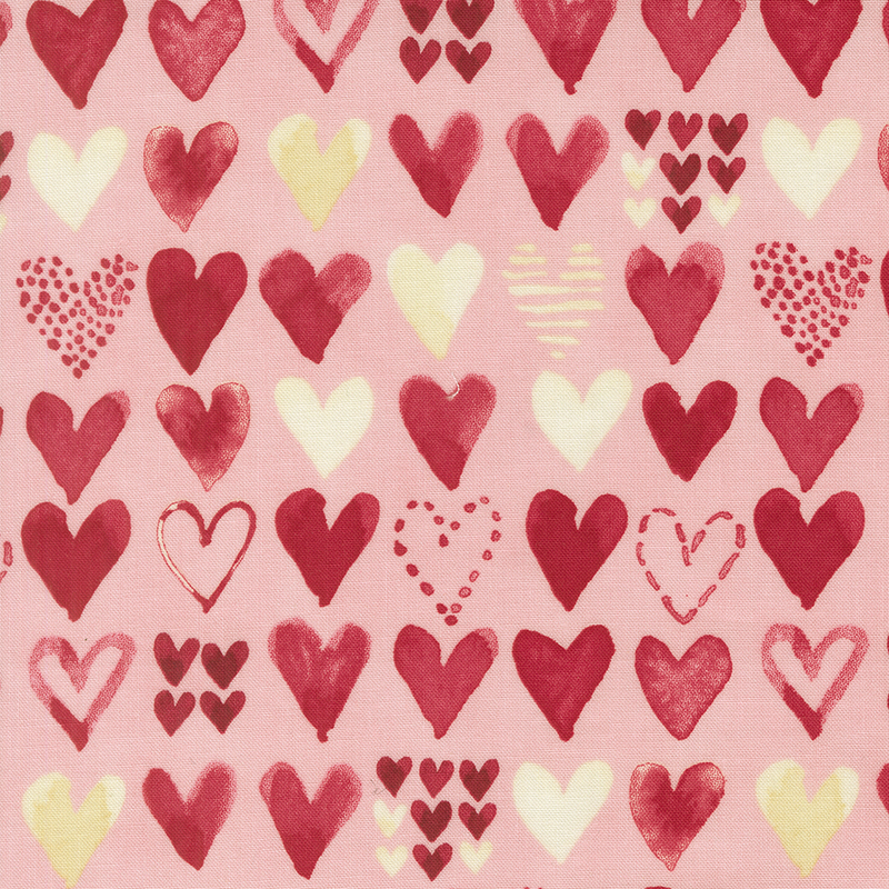 Light pink fabric with rows of red and cream watercolor hearts in varying designs.