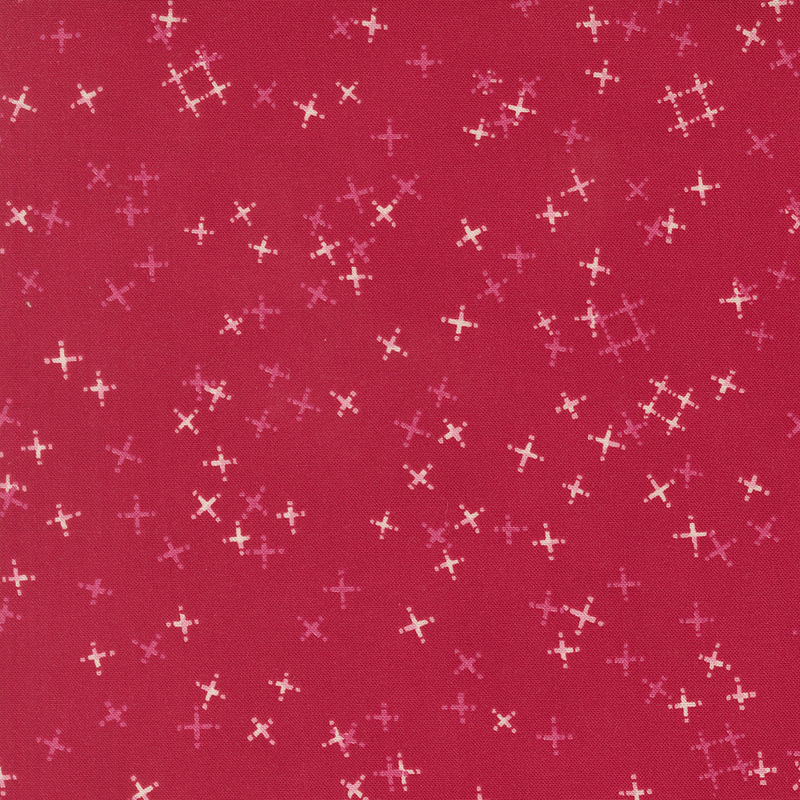 Cherry red fabric with tossed light pink and tonal crosses and pound signs.