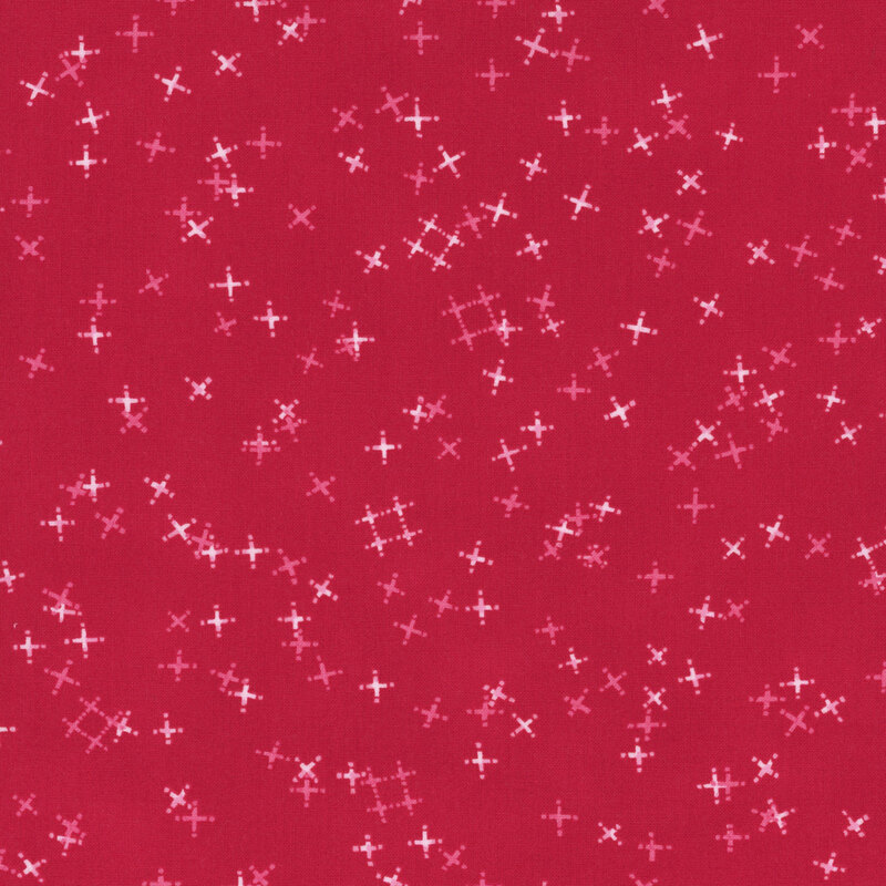 Cherry red fabric with tossed light pink and tonal crosses and pound signs.