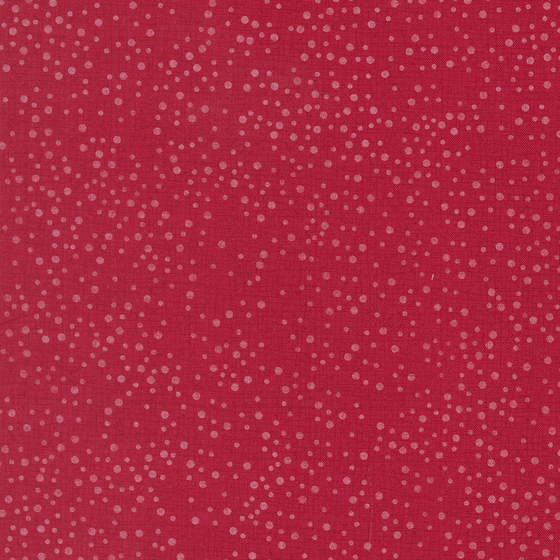 Cherry red fabric with tonal thatching and scattered dots.