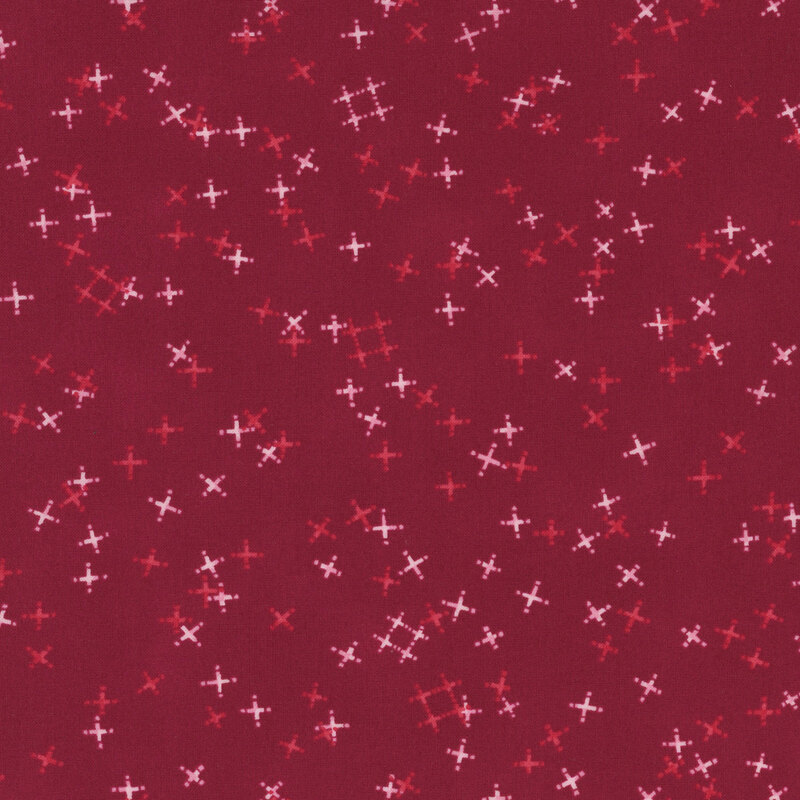 Cranberry red fabric with tossed light pink and tonal crosses and pound signs.