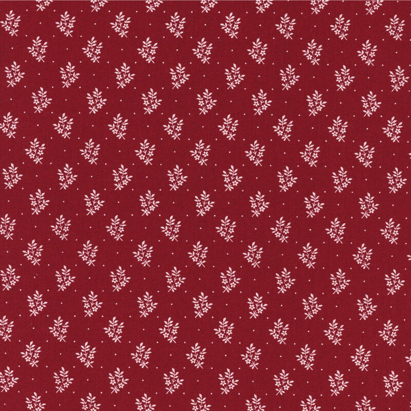 Red fabric with a repeating white floral pattern on a dark red background.