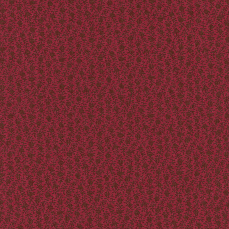 Textured red fabric with a subtle floral pattern.