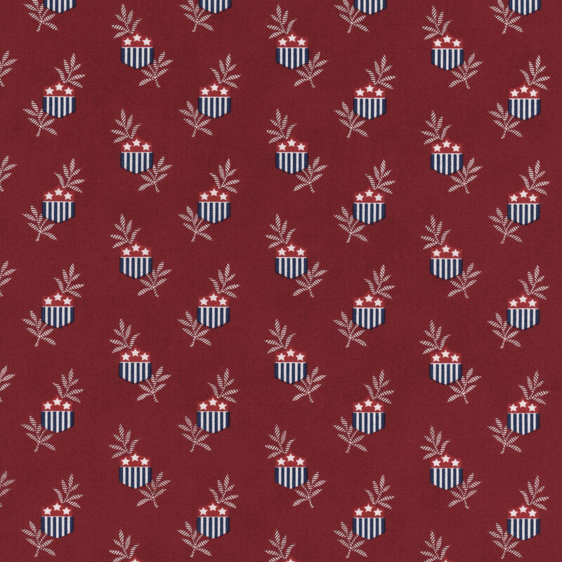 Red fabric featuring a repeating pattern of shield emblems with stars and leaves.
