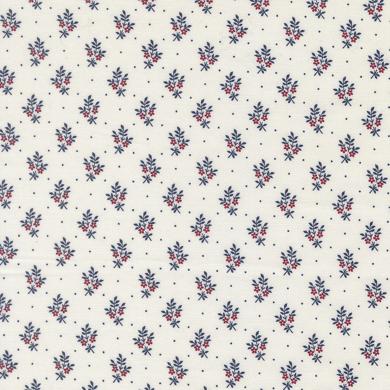 A fabric pattern featuring small blue and red floral designs on a cream background.