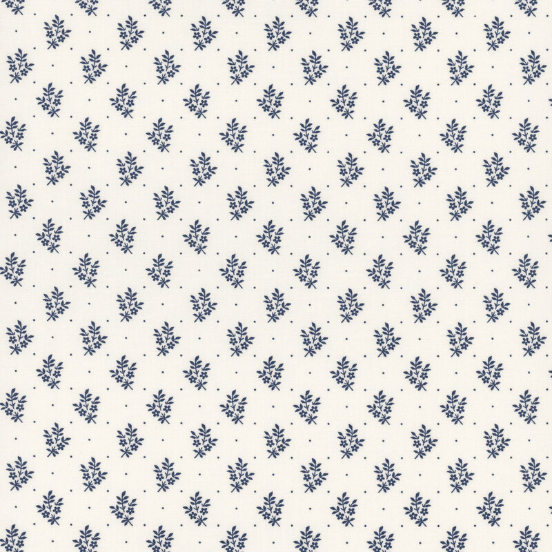 Patterned fabric featuring small blue floral motifs on a cream background.