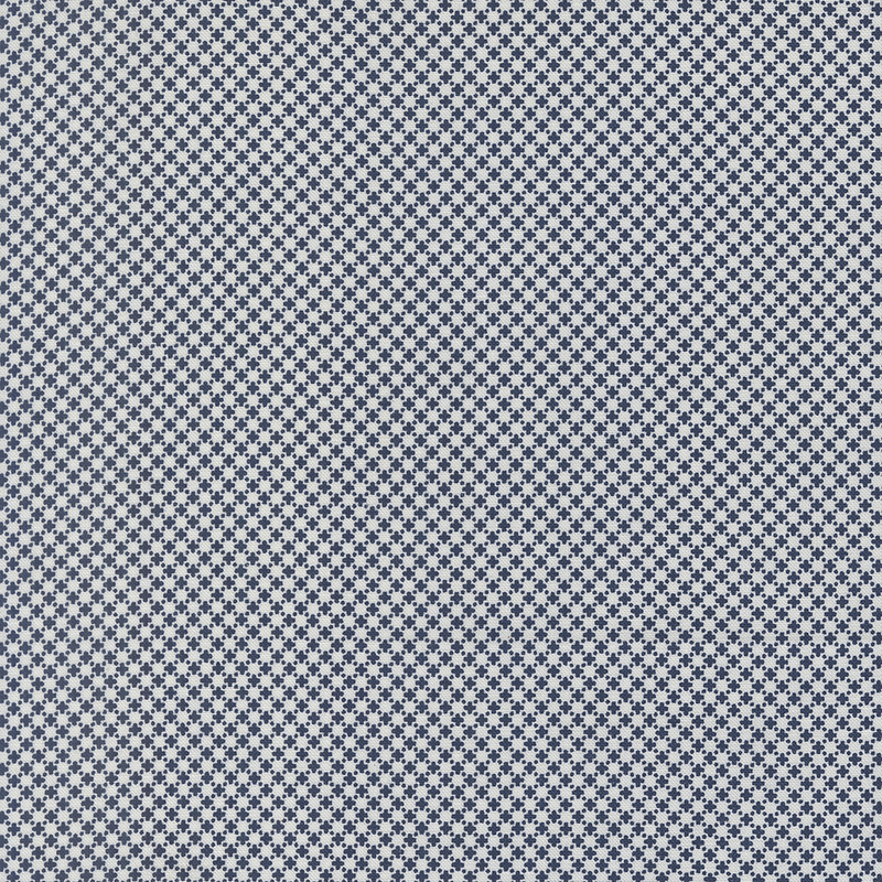 A textured fabric pattern featuring a repeating small navy blue and white cross design.