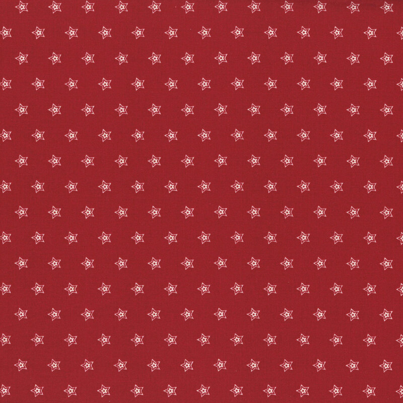 Red fabric with a repeated pattern of small white star shapes.