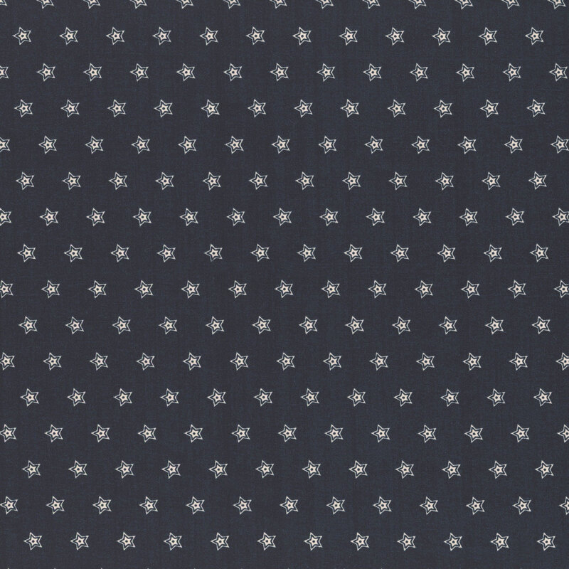 A dark fabric background patterned with small, white star shapes evenly spaced throughout.