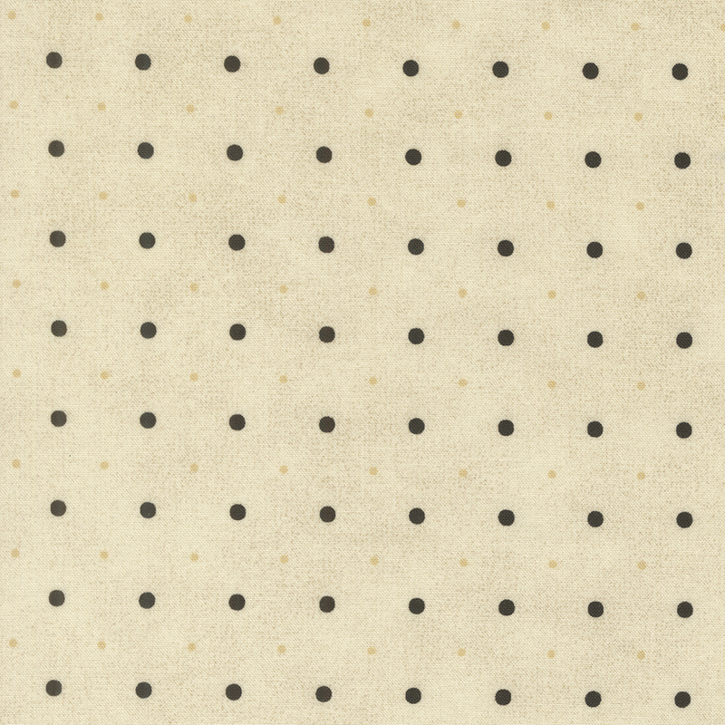 A cream fabric with small and medium sized black and tonal polka dots.