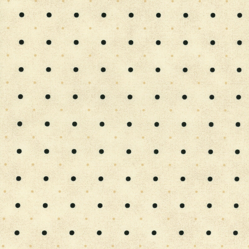 A cream fabric with small and medium sized black and tonal polka dots.