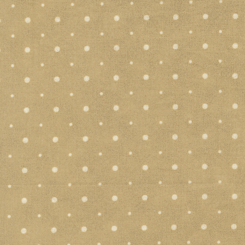 A tan fabric with small and medium sized cream polka dots.