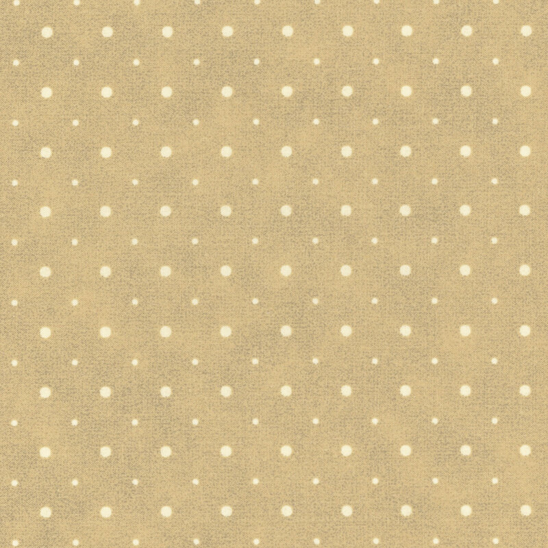 A tan fabric with small and medium sized cream polka dots.