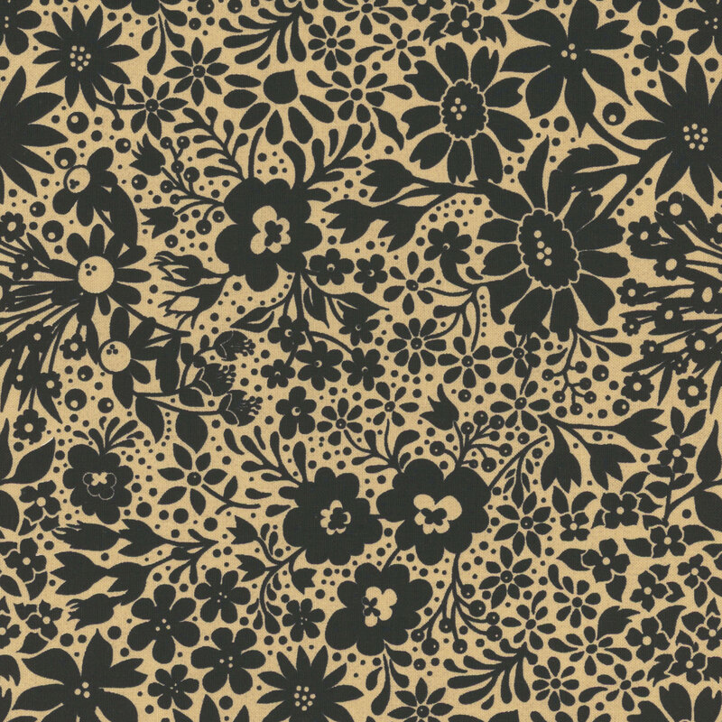 Tan fabric with a dense pattern of stylized floral silhouettes in black.