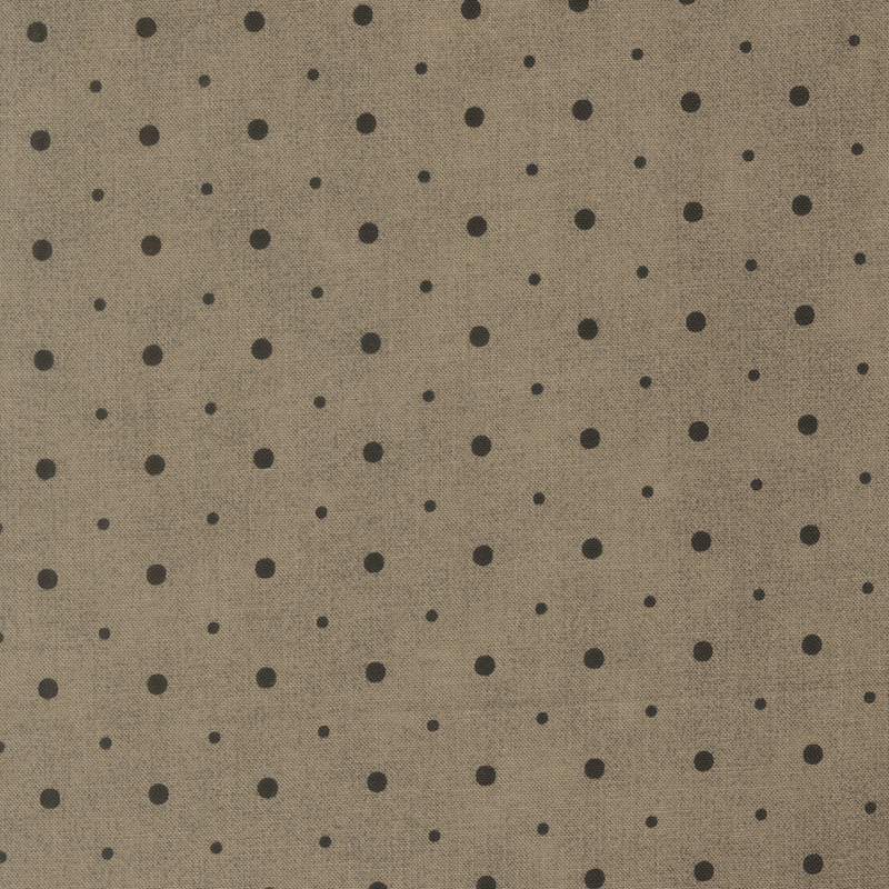 A dark greige fabric with small and medium sized black polka dots.