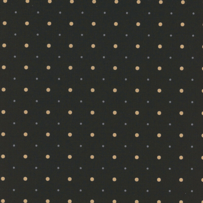 A black fabric with small and medium sized tan and tonal gray polka dots.