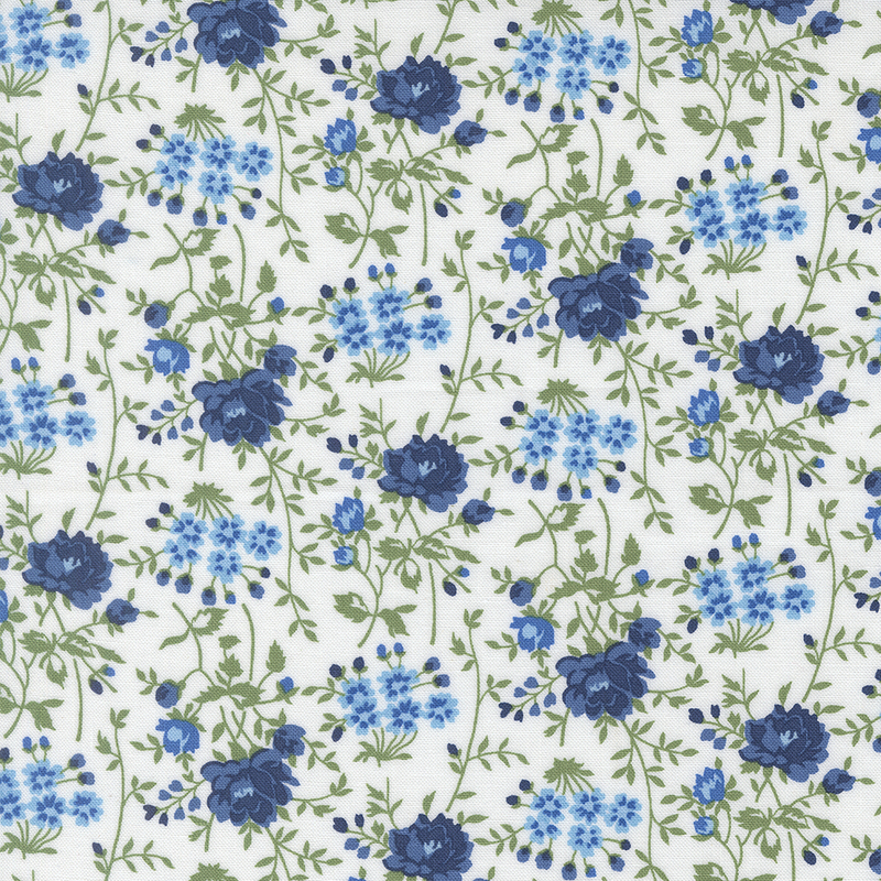 White fabric with navy and light blue florals with sprawling green stems.