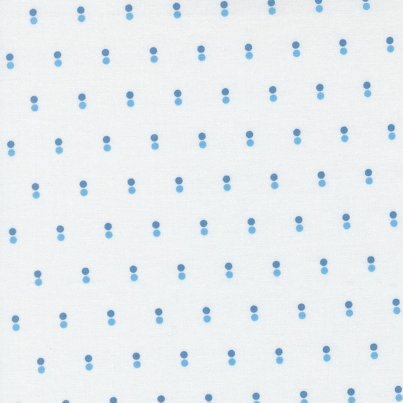 White fabric with rows of parallel dots in light and dark blue.