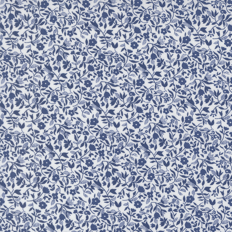 White fabric with a packed design of navy florals and sprawling leaves.