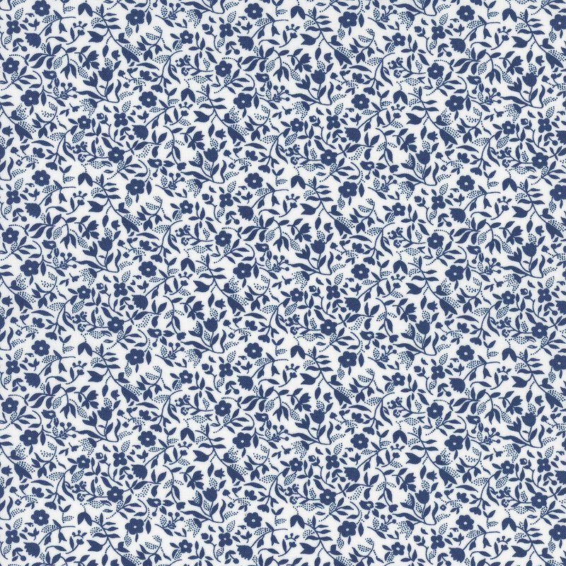 White fabric with a packed design of navy florals and sprawling leaves.