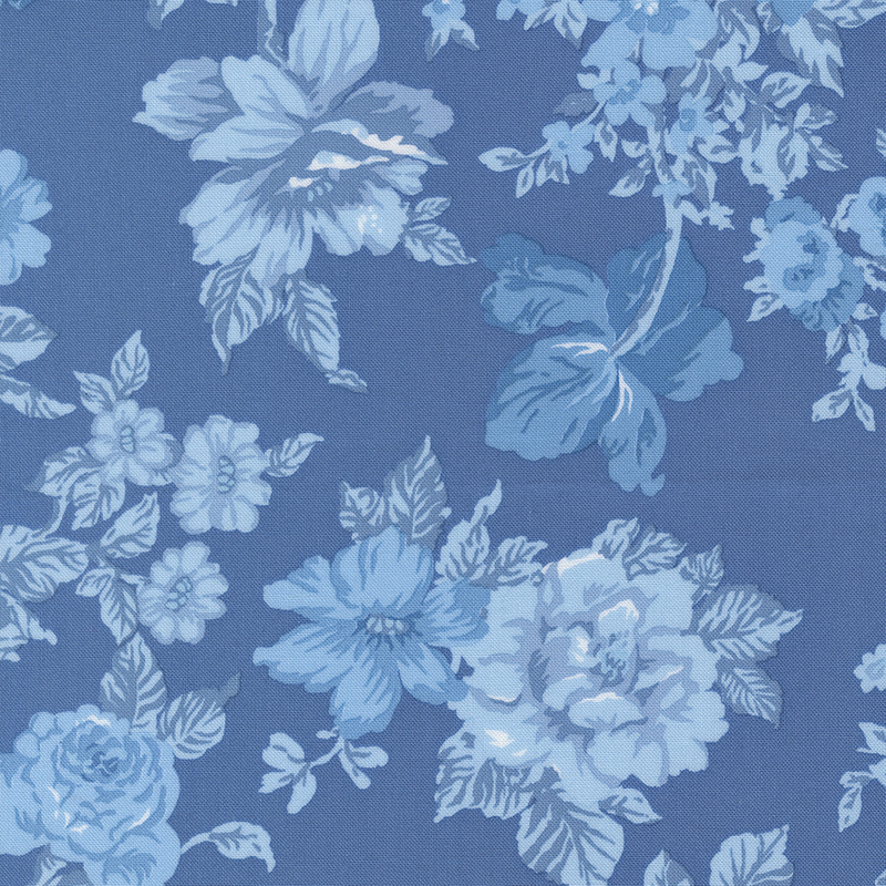 Blue fabric with tonal light and dark florals and leaves.