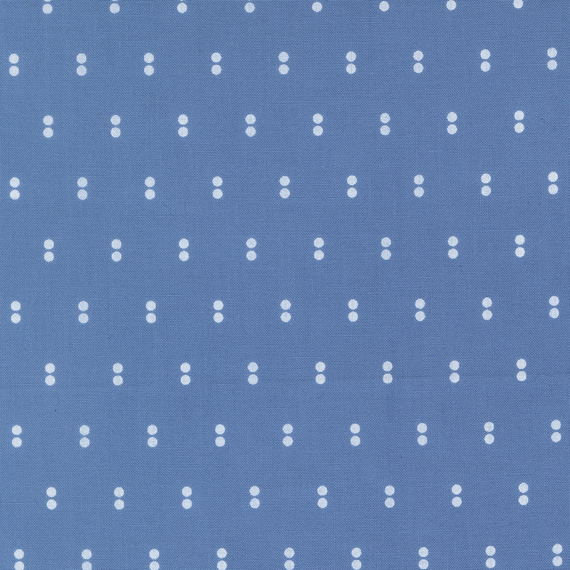Blue fabric with rows of parallel white dots.