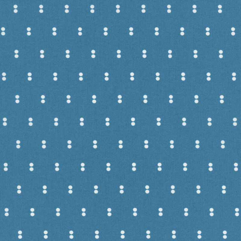 Blue fabric with rows of parallel white dots.