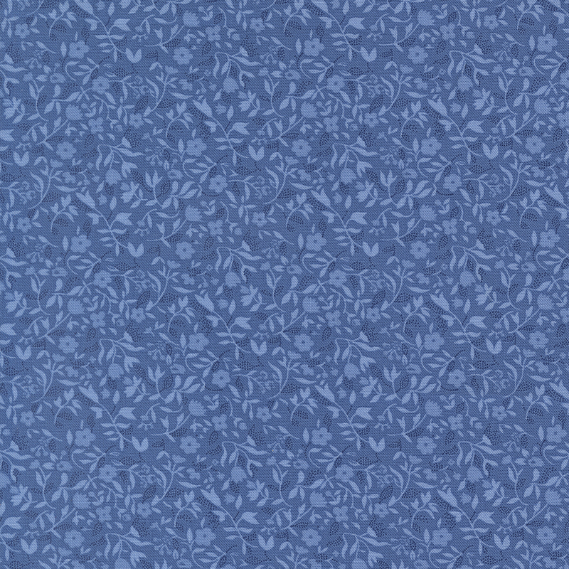 Blue fabric with a packed design of tonal florals and sprawling leaves.
