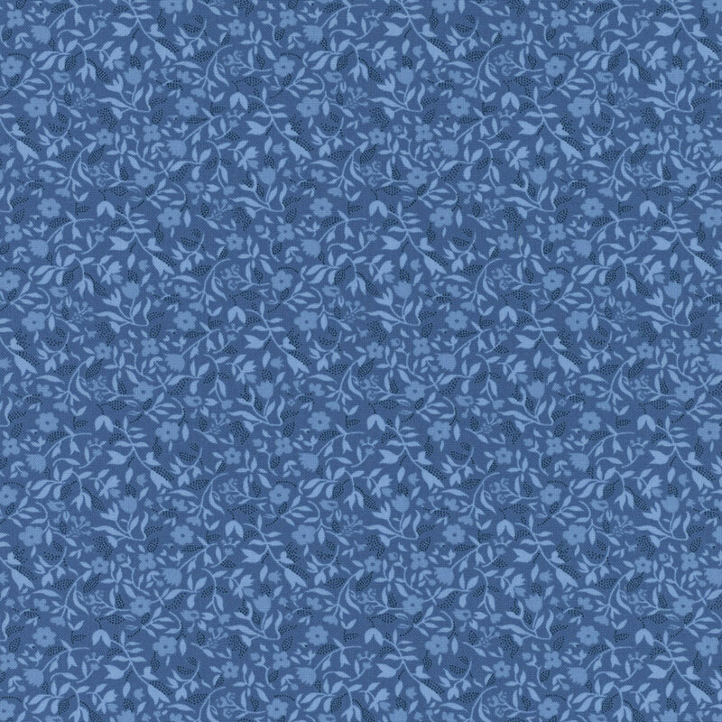Blue fabric with a packed design of tonal florals and sprawling leaves.