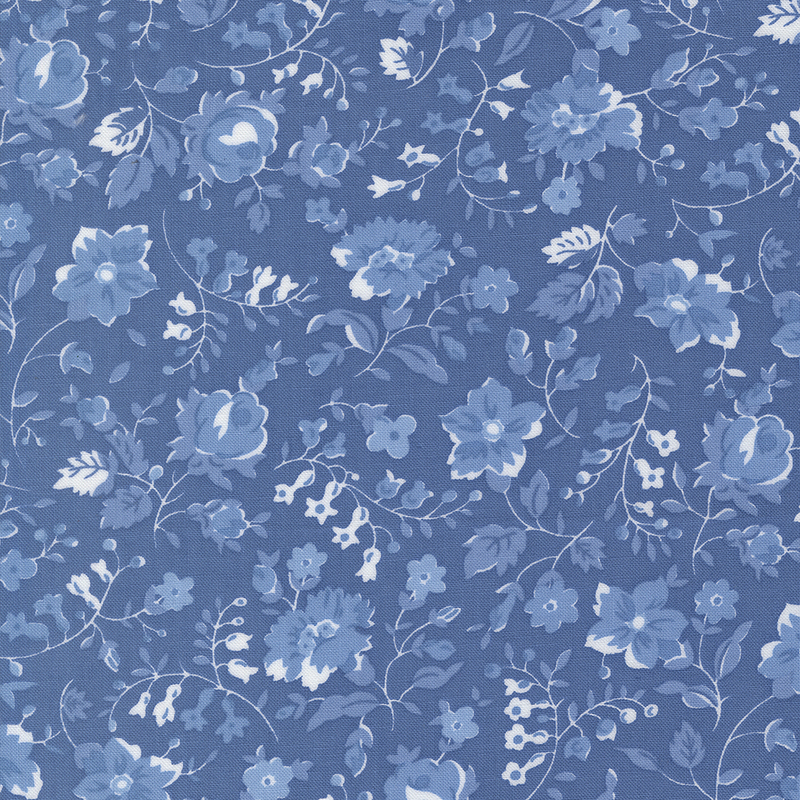 Light blue fabric with blue and white florals, sprawling leaves, and stems.