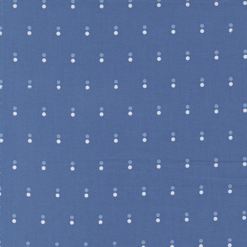Blue fabric with rows of parallel white and light blue dots.