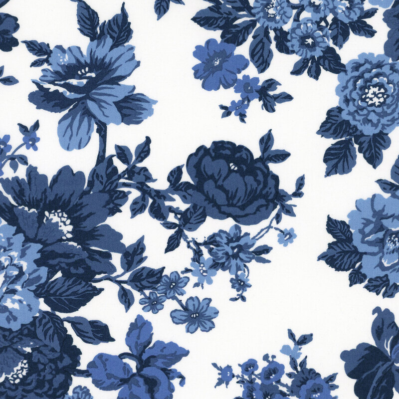 White fabric with dark blue florals and leaves.