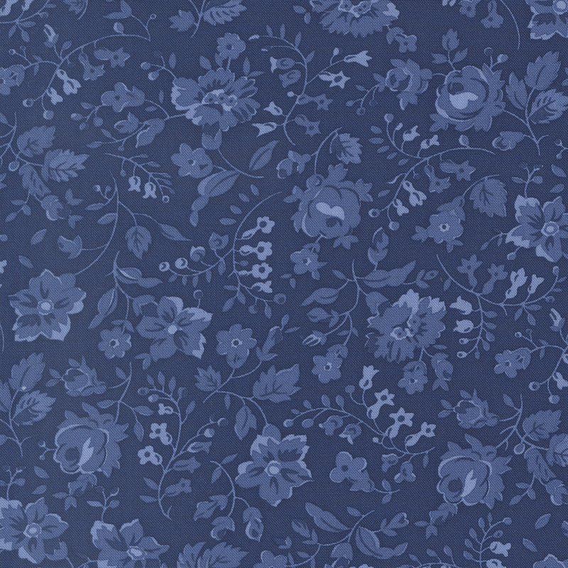 Blue fabric with tonal florals and sprawling leaves and stems.