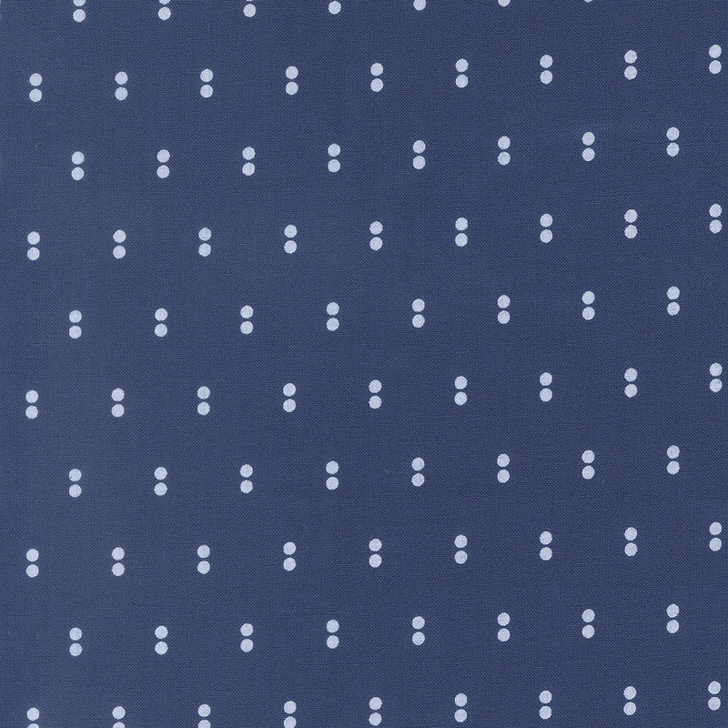 Navy fabric with rows of parallel white dots.