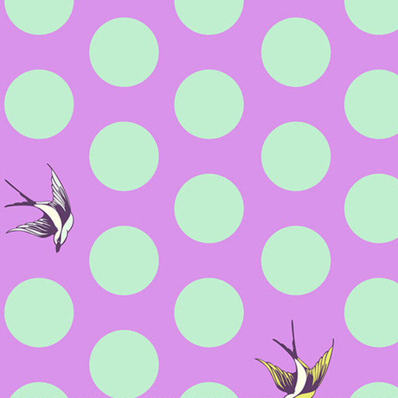 A bright purple fabric with large mint green dots and tossed starlings.