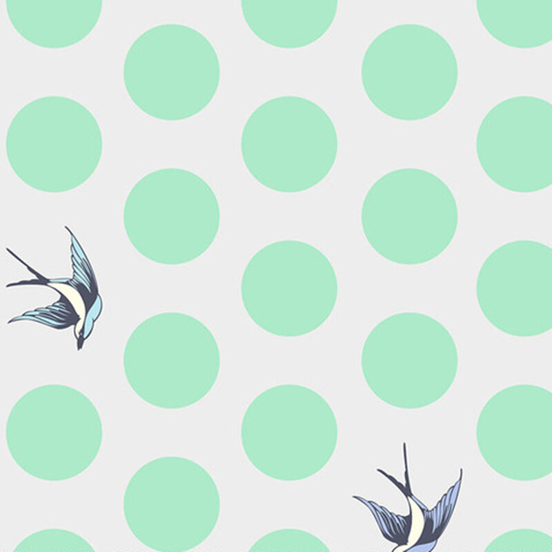 A pale gray fabric with large mint green dots and tossed starlings.