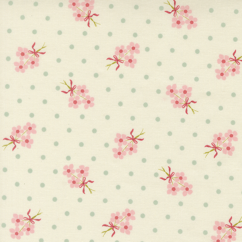 Cream fabric with blue polka dots and fluffy pink floral bouquets.