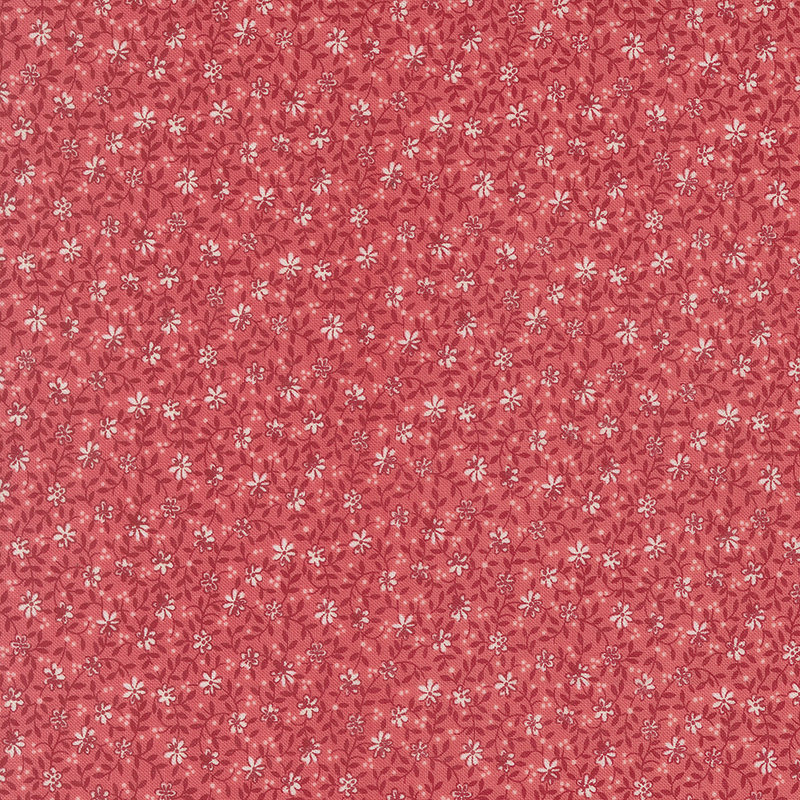 Red fabric with a white and tonal dense floral and leaf design.