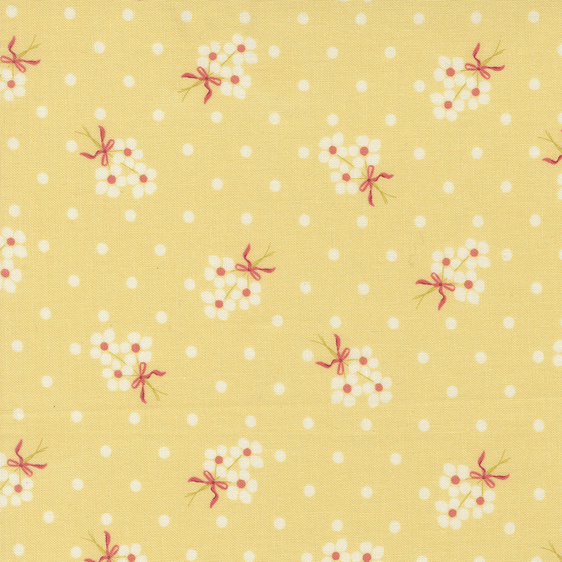 Yellow fabric with cream polka dots and fluffy cream floral bouquets.