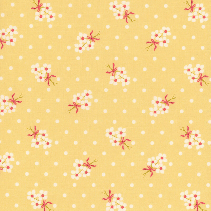 Yellow fabric with cream polka dots and fluffy cream floral bouquets.