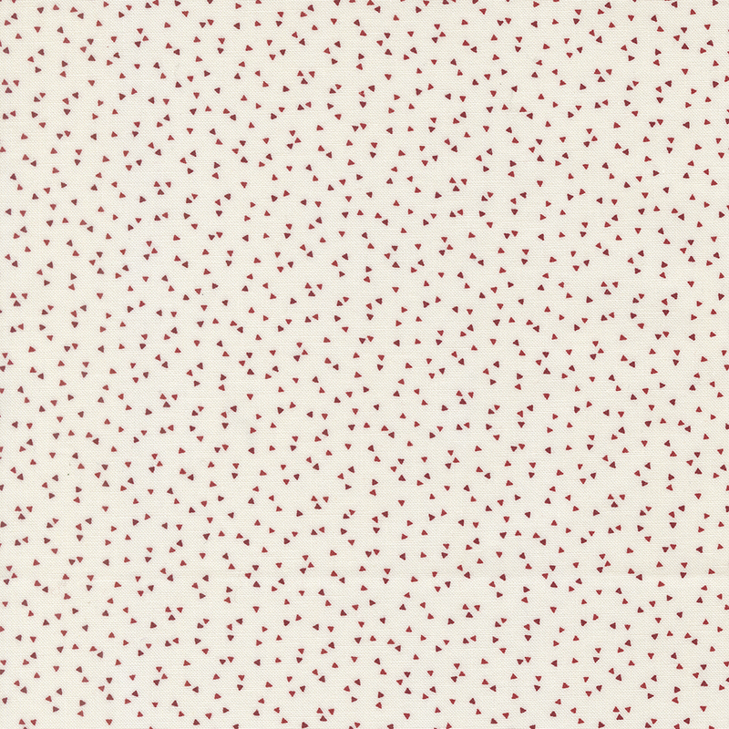 A cream-colored fabric pattern featuring small, scattered red hearts.