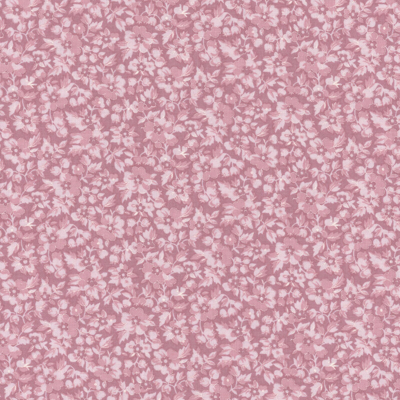 Repeating floral pattern in shades of pink on a fabric.