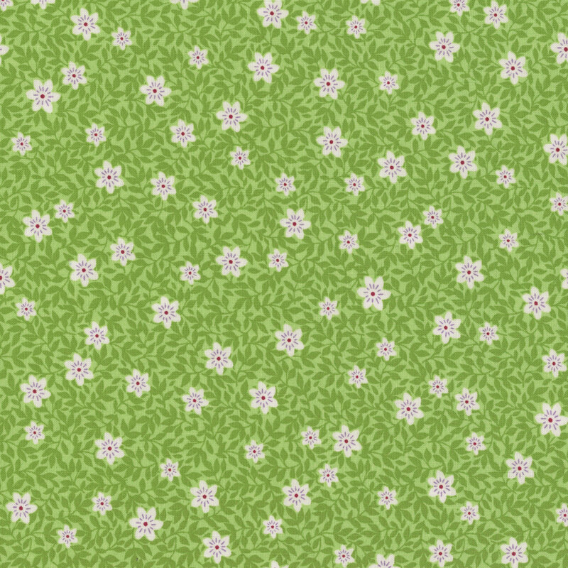 Green fabric with tonal leaves and white florals.