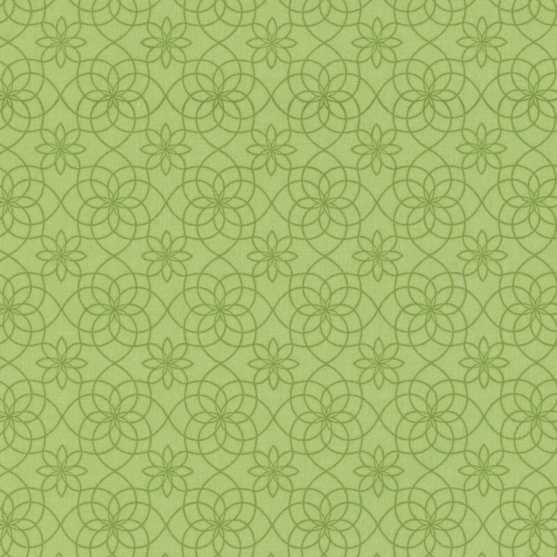 Green fabric featuring a floral and circular pattern with intricate lines and flowers.