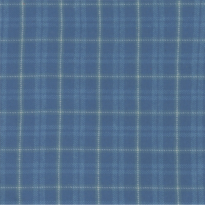 Blue fabric with a white and green plaid pattern.