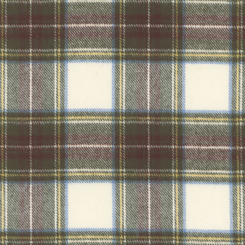 Flannel fabric with green, brown and yellow plaid on a cream background.