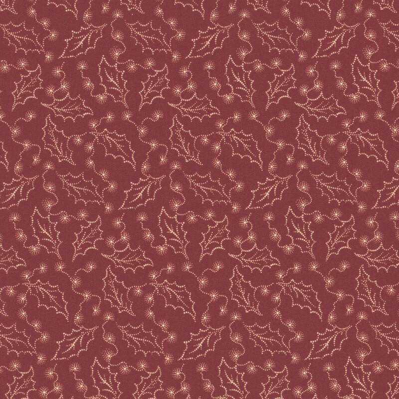 Red fabric with tossed holly leaves and small tan bursts of color.