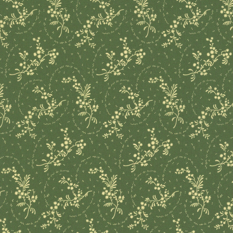 Green fabric with tossed leafy springs on an ornate background.