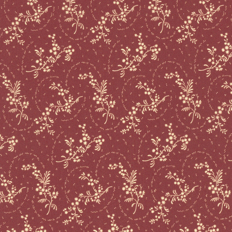 Red fabric with tossed leafy springs on an ornate background.
